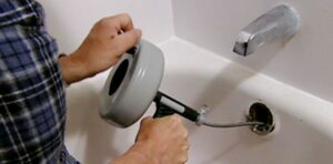 Hand Auger working on tub drain